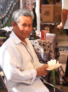 Adding finishing touches to a corn husk blossom