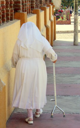 A sister with walker on a sidewalk in San Juan Cosalá