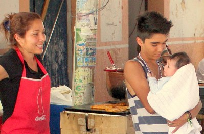 A young fathers cradles his infant son