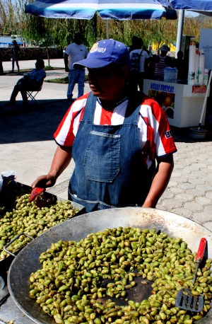 A street vendor cooks unshelled garbanzo beans