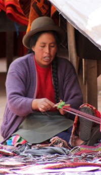 Native artisan weaving on a simple belt loom