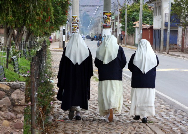 Sisters walking Yucay's main street.