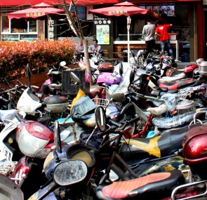 Auto ownership is skyrocketing in Shanghai, but scooters are still the only transport for many.