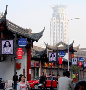 Modern ads and skyscraper make for sharp contrasts.